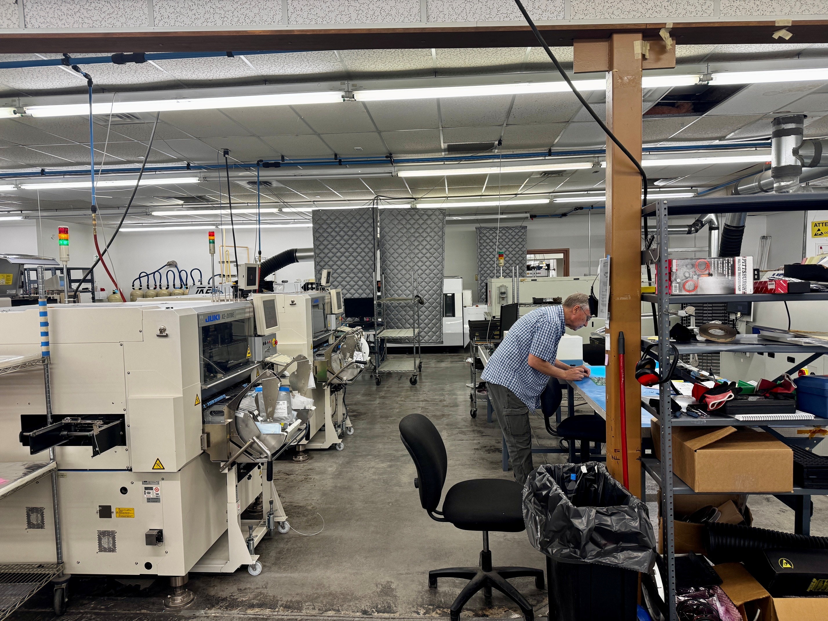 SMT manufacturing floor with worker